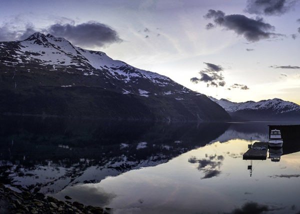 Sunrise reflecting off of the Bay in Whittier Alaska with mountains in background